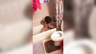 Shaping her bush in the tub