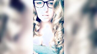 Teasing with long curls and glasses