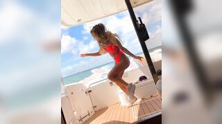 Fit girl do some shuffle dancing on a fast boat