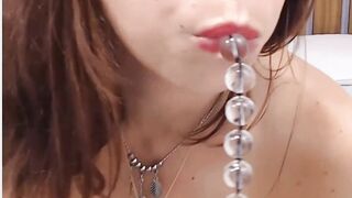 Cam girl sucks on anal beads one by one